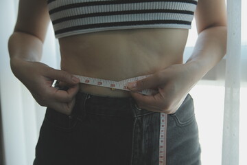 Women body fat belly. Obese woman hand holding excessive belly fat. diet lifestyle concept to reduce belly and shape up healthy stomach muscle.