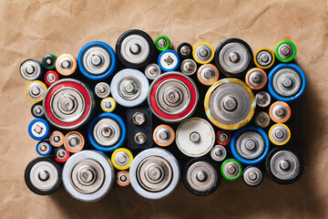 Assorted Used Batteries Arranged on a Brown Paper