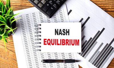 Nash Equilibrium text on a notebook with chart and calculator