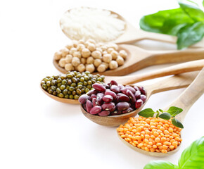 assortment of cereals peas beans lentils in spoons