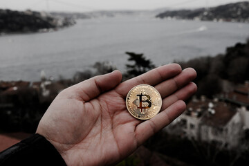 symbolic bitcoin money in my hand or on the rock