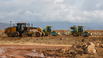 construction machines at works, dozer, roller machine, excavator, crawler rock drill machine, trucks, GPS grader © selcukbulbul