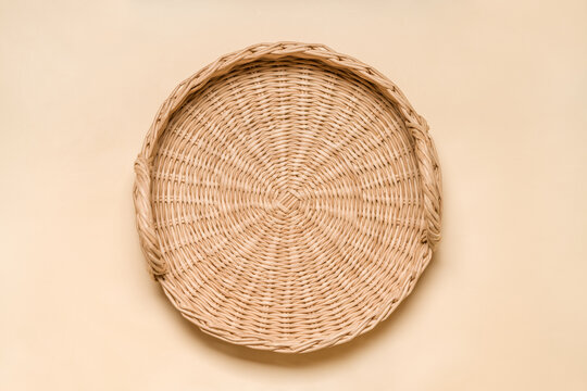 Handwoven Eco-Friendly Tray: Top View of Handcrafted Rattan and Paper Wicker Serving Tray on Beige Surface