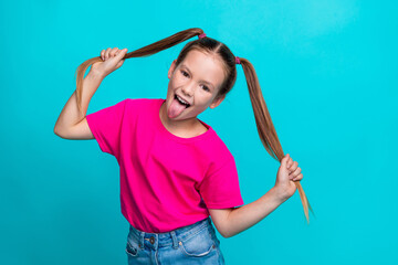 Photo of cheerful glad girl wear trendy pink clothes two arms touch ponytails have fun summer holidays isolated on cyan color background