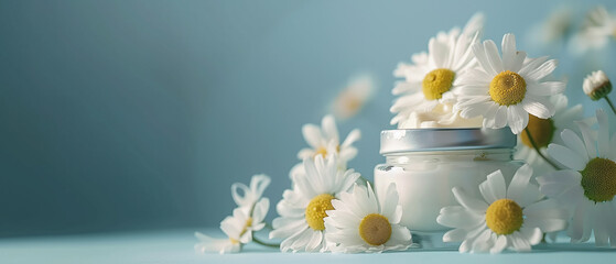 A bouquet of chamomile flowers in a jar and a jar of cream. Chamomile in creams and cosmetics