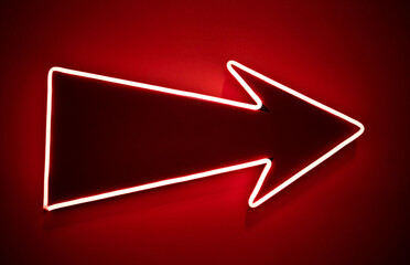 isolated arrow with neon outline glowing on red background