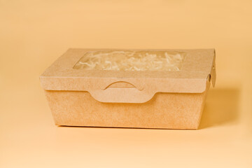 Side View of Eco-Friendly Packaging: Cardboard Box on Beige Background