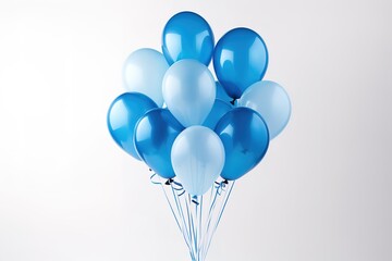 Blue and white balloons against a white wall background