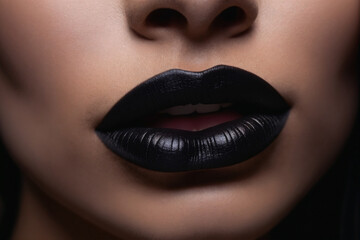 The black hue of her black lipstick adorns her lips like a precious organ, highlighting their allure in a captivating closeup
