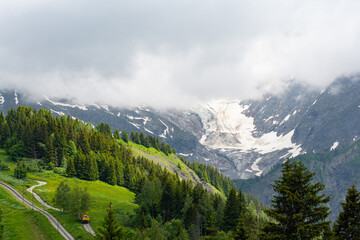 Picturesque panoramic view of the snowy Alps mountains, glacier and meadows while hiking Tour du...