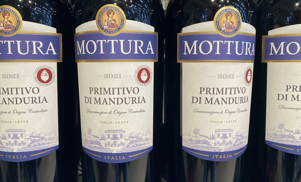 Viersen, Germany - January 9. 2024: Closeup of bottles italian Mottura Primitivo di Manduria red wine in shelf of german store