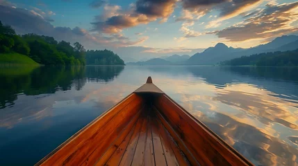 Gartenposter Calm lake with morning skies above view from wooden boat © Rosie
