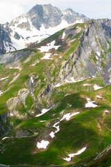 Picturesque panoramic view of the snowy Alps mountains and meadows while hiking Tour du Mont Blanc....