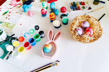 Happy Easter! Painting eggs. Happy family painting eggs for Easter celebration.