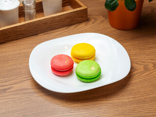 Colored macarons on a plate. Dessert.
