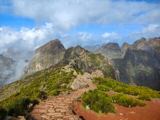 Beautiful mountain hiking trail from Pico do Arieiro to Pico Ruivo. Rocks and cloudy sky in Madeira island, Portugal