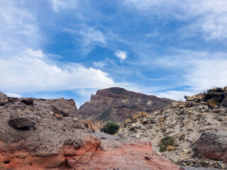 Hike trail scenery in El Teide crater on Tenerife. Red volcanic rock statue. Colourful background