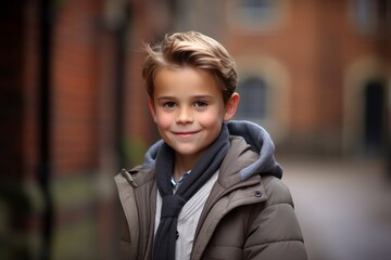 Portrait of a cute young boy in a coat and scarf.