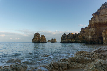 View from beach Praia do Camilo at the atlantic coast line at rock formations in the sea, Lagos,...