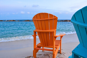 Colorful wooden chairs on beach at Caribbean coast. 