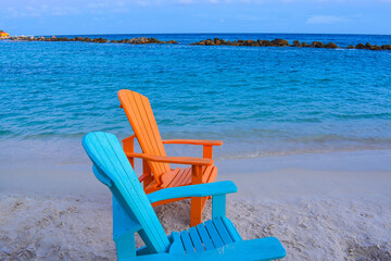 Colorful wooden chairs on beach at Caribbean coast. 