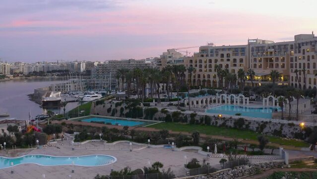 High Aerial shot orbiting around the coast of St Julians Malta