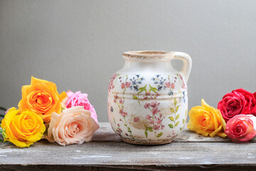 Ceramic vase and colorful rose flowers.