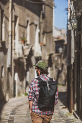 Rear view of a man exploring Italian city Erice
