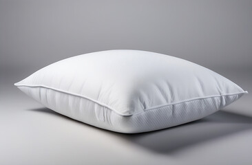 Fototapeta na wymiar One white pillow separately on a gray background. Side view