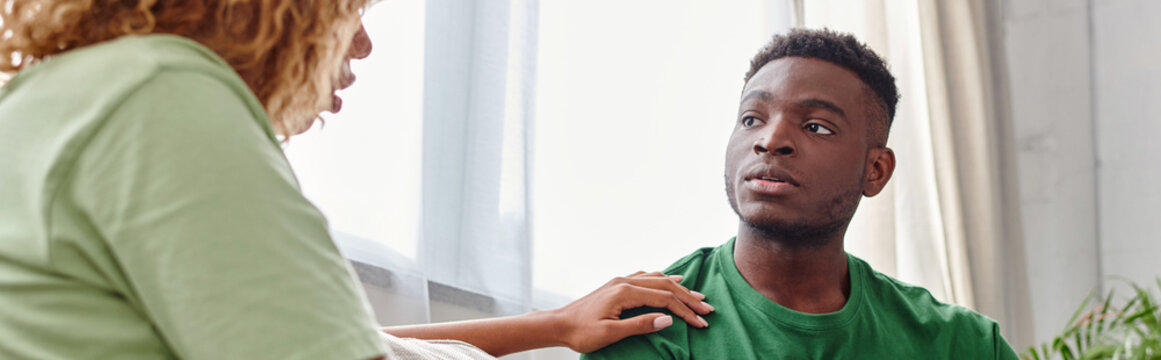 Black Woman Touching Shoulder Of Concerned Boyfriend While Supporting Him At Home, Banner