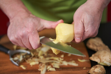 Cook peeling and cleaning ginger