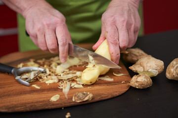 Cook peeling and cleaning ginger