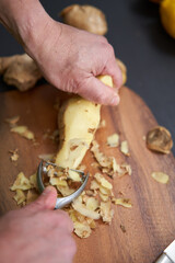 Cook peeling and cleaning ginger