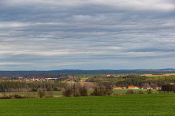 Fototapeta na wymiar Early springtime in European countryside. Villages on the horizon.