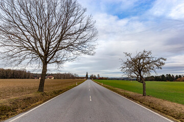 Countryside road in Europe. Early springtime.