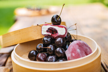Wooden bowl with cherries and ice cream a sweet and fruity dessert dish. Asian dessert mochi