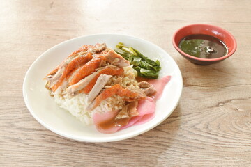slice roasted duck topping rice with pink pickled ginger and boiled cabbage dressing sweet soy sauce on plate