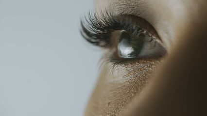 Macro shot of female model face. African American woman shot cropped face, green eyes looking away...