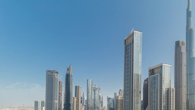 Panorama showing aerial view of Dubai Downtown and Business bay skyline with many towers timelapse. Business area in smart urban city. Skyscraper and high-rise buildings from above, UAE.