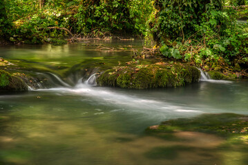 Turquoise color of water in the summer on the river Janj