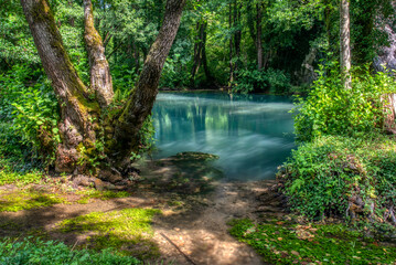 Turquoise color of water in the summer on the river Janj