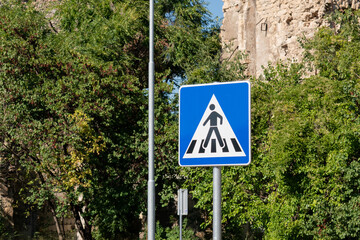 Pedestrian crossing or crosswalk sign in urban area, street sign
