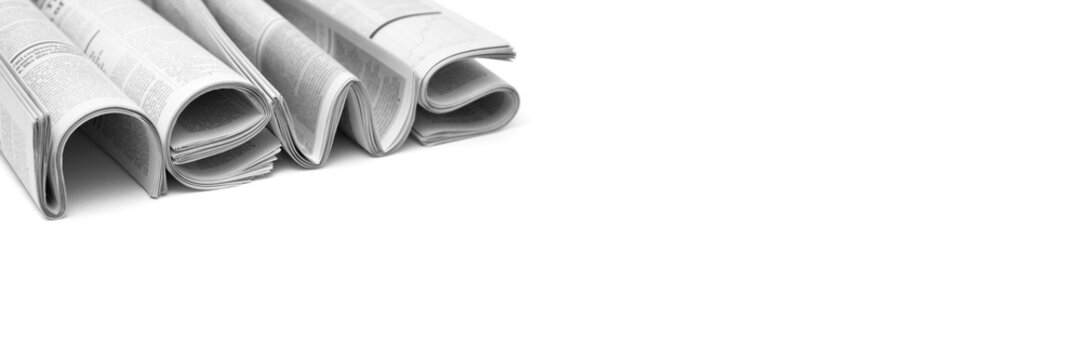 Modern newspapers are folded and composing together the word NEWS, isolated over background. Concept of business news, news media, print media and mass media at all. Copy space for your text