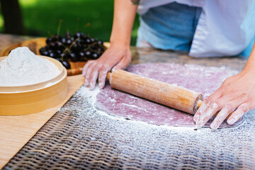 a person is rolling dough with a rolling pin on a table. Mochi asian dessert