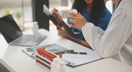 biochemical research scientist team working with microscope for coronavirus vaccine development in pharmaceutical research labolatory, selective focus