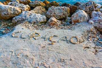 Curacao word made of pebbles on the beach in Curacao, Netherlands Antilles. 