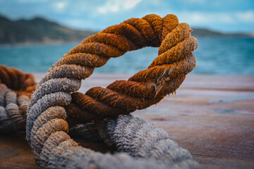 old rope on the wood boat deck blu sky clouds by the sea