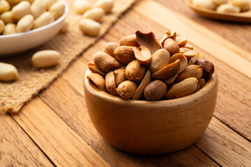 Close up Air fryer Roasted peeled peanuts in wooden bowl.rich in protein,fat,and fiber