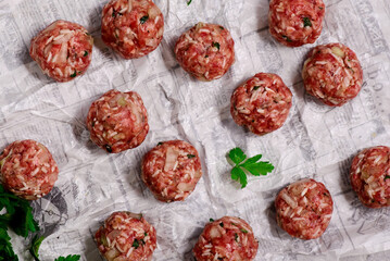 Raw beef meatballs on a cutting board .style hugge.top veiw