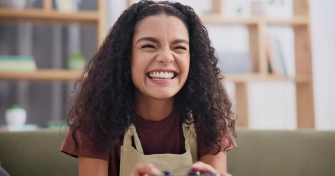 Home, controller and woman with video game, smile and excited with weekend break and relaxing in a living room. Person, gamer and girl on a couch, esports and entertainment with console and happiness